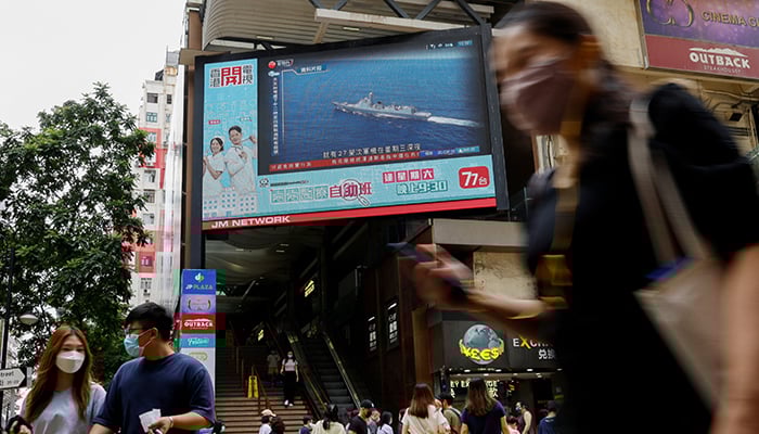 A TV screen shows China's People's Liberation Army starting military drills, including live fire in the waters and airspace surrounding the island of Taiwan, on August 4, 2022 in Hong Kong, China. — Reuters