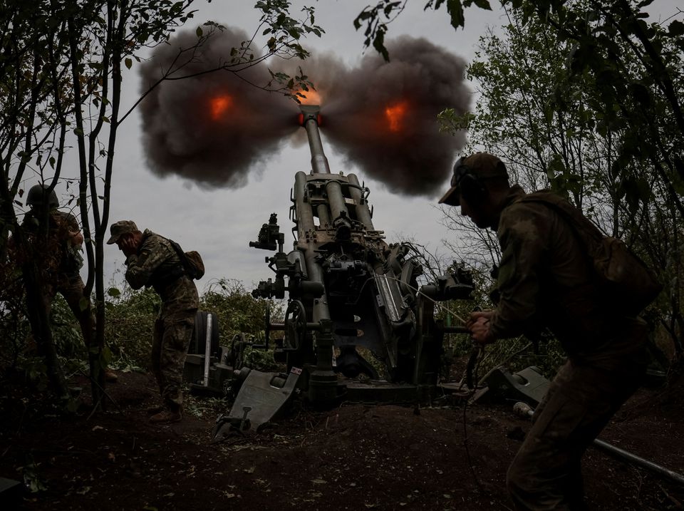Ukrainian service members fire a shell from a M777 Howitzer at a front line, as Russias attack on Ukraine continues, in Kharkiv Region, Ukraine July 21, 2022.