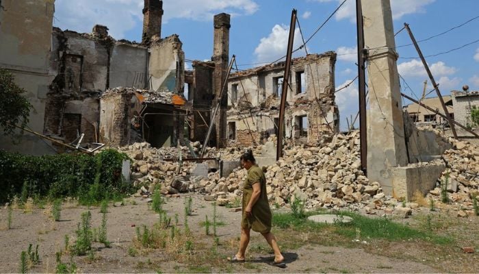 A local resident walks near the ruins of a destroyed apartment building during Ukraine-Russia conflict in the city of Lysychansk in the Luhansk Region, Ukraine July 5, 2022. — Reuters