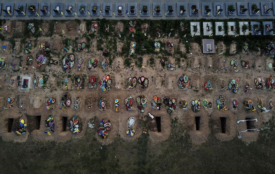 Fresh holes dug ahead of new funerals sit next to dozens of recent graves, many of which have been filled by those who have died since Russia invaded months ago, in the Walk of Heroes section of the cemetery, which contains those who served as military members, fire fighters and police officers as Russia’s attack continues in Kharkiv, Ukraine, July 5, 2022.