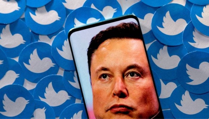 An image of Elon Musk is seen on smartphone placed on printed Twitter logos in this picture illustration taken April 28, 2022.— Reuters