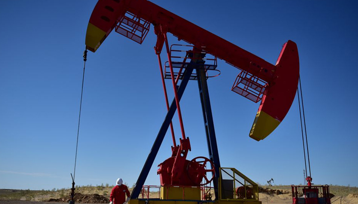 A PetroChina worker inspects a pump jack at an oil field in Tacheng, Xinjiang Uighur Autonomous Region, China June 27, 2018. — Reuters