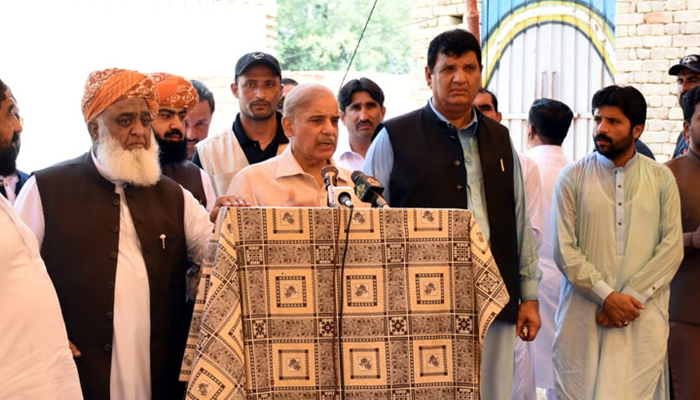 Prime Minister Shehbaz Sharif (centre) addresses a press conference alongside Pakistan Democratic Movement chief Maulana Fazlur Rehman (left) and other coalition partners in a district of Khyber Pakhtunkhwa, on August 4, 2022. — RadioPakistan