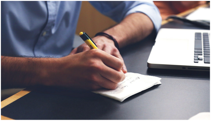 Representational image of a man writing something on a piece of paper. — Pixabay/ StartupStockPhotos