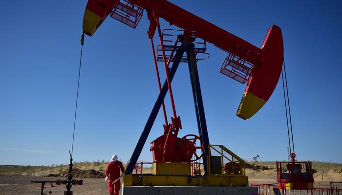 FILE PHOTO - A PetroChina worker inspects a pump jack at an oil field in Tacheng, Xinjiang Uighur Autonomous Region, China June 27, 2018. — Reuters/File