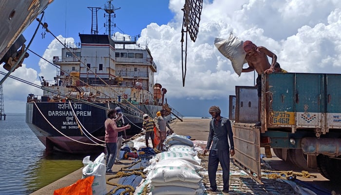 Labourers unload rice bags from a supply truck at Indias main rice port at Kakinada Anchorage in the southern state of Andhra Pradesh, India, September 2, 2021. — Reuters