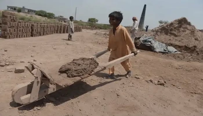 A Pakistani boy works with his family at a brick kiln on the outskirts of Islamabad in this 2014 AFP file photo