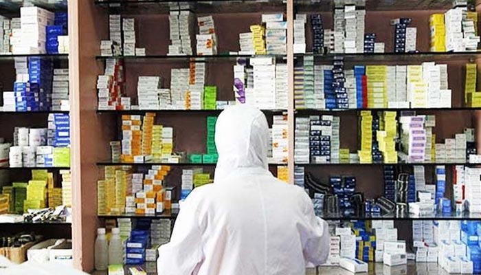 A representational image of a chemist looking for medicines in his store. — AFP/File