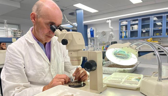Australian Microplastic Assessment Project Research Director Dr Scott Wilson looks at microplastics through a microscope at Macquarie University in Sydney, Australia, April 15, 2021. — Reuters/File