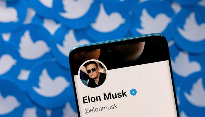 Elon Musks Twitter profile is seen on a smartphone placed on printed Twitter logos in this picture illustration taken April 28, 2022. — Reuters/File