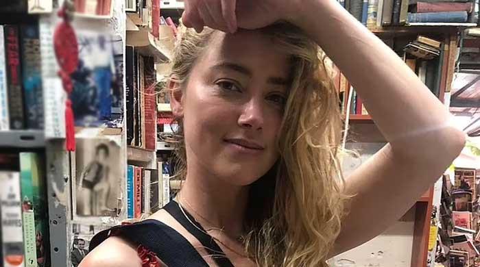 Amber Heard leaves onlookers spellbound with her appearance in red maxi dress