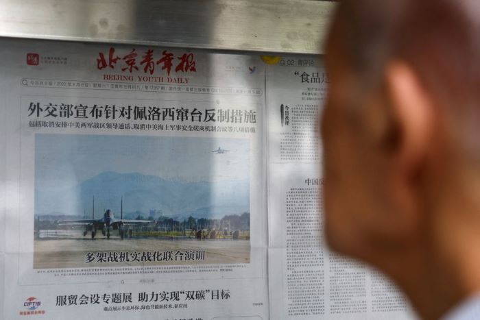 A man reads a newspaper report with an image of military exercises near Taiwan by the Chinese Peoples Liberation Armys (PLA) Eastern Theatre Command on the front-page, at a newspaper stand in Beijing, China, August 8, 2022. Photo: Reuters