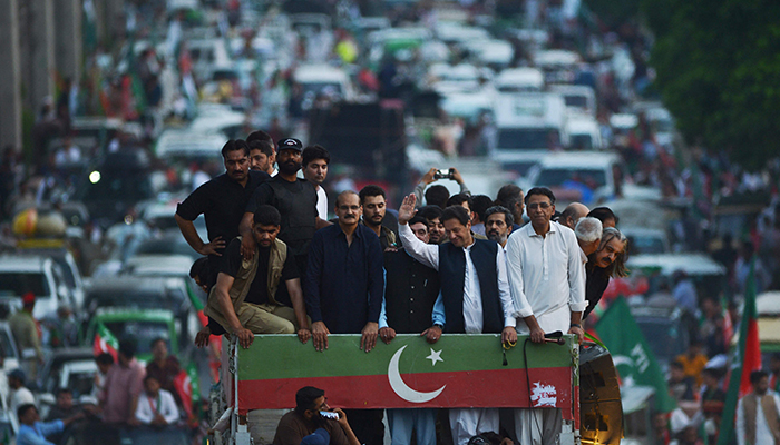 Pakistans former prime minister and leader of the opposition party Pakistan Tehreek-e-Insaf (PTI) Imran Khan (front 2R) waves at supporters during a protest rally against inflation, political destabilisation, and continued hikes in fuel prices, in Rawalpindi on July 2, 2022. — AFP/File