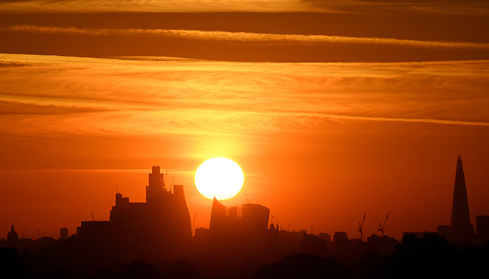 The sun rises behind the London skyline as a second heatwave is predicted for parts of the country, Richmond Park, London, Britain, August 8, 2022. — Reuters