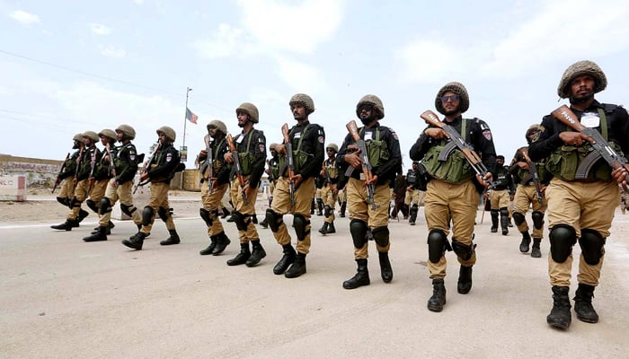 Security personnel stand high alert during the procession on 9th Muharram-ul-Haram to safeguard the mourners. —APP