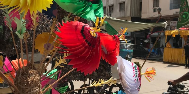 Colourful toy fans sold on the streetside - Image by author