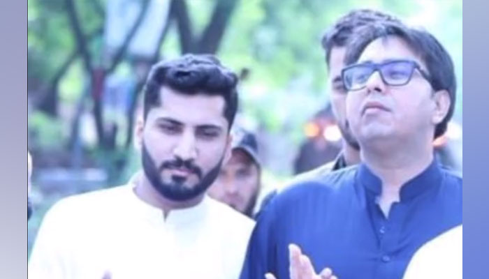 PTI leader Shahbaz Gill with his driver Izhar. — Screengrab from a Twitter video posted on PTIs account