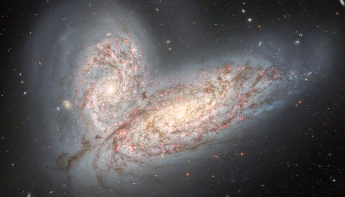 The merging galaxies NGC 4568 (bottom) and NGC 4567 (top). — International Gemini Observatory/NOIRLab/NSF/AURA)
