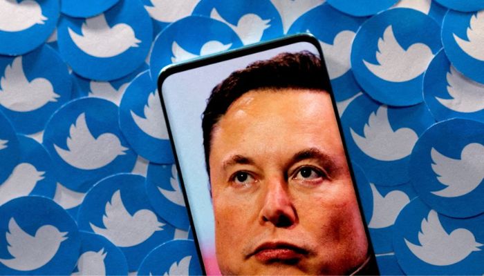 An image of Elon Musk is seen on smartphone placed on printed Twitter logos in this picture illustration taken April 28, 2022. — Reuters