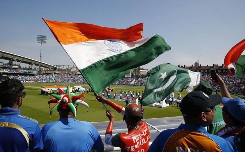 A representational of people in the crowd raising their countries flags high during a high0-tension clash between India and Pakistan. — Reuters/File