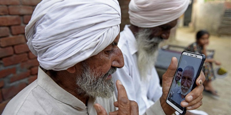 In this picture taken on August 2, 2022, Indian Sikh labourer Sika Khan talks to his brother Sadiq on a video call.