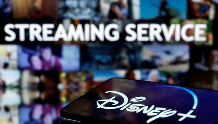 A smartphone screen showing the Disney+ logo is seen in front of the words streaming service in this illustration taken March 24, 2020.— Reuters