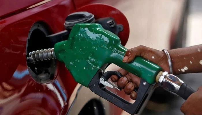 A car at a fuel station getting its tank filled at a petrol pump. — Reuters/File