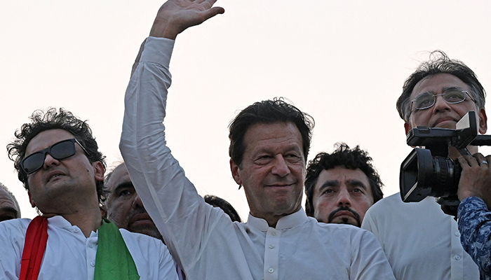 Pakistans former prime minister and PTI Chairman Imran Khan waves to supporters during a protest rally in Attock on May 25, 2022. — AFP