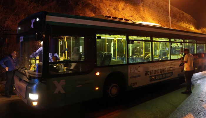 Israeli security inspect a bus after an attack outside Jerusalem’s Old City on Sunday. Several people were injured, two of them critically. — AFP