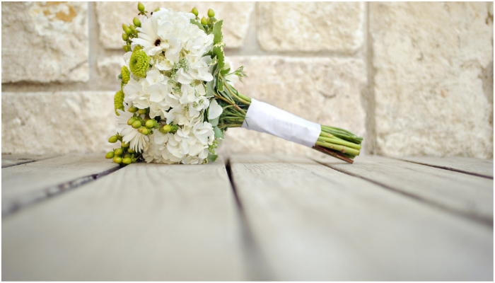 Image showing a wedding bouquet lying on the floor. — Unsplash/ Jamie Coupaud
