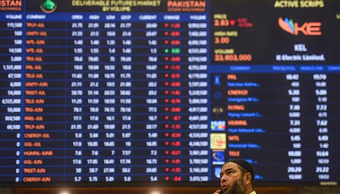 A stockbroker speaks on a phone while monitoring the share prices during a trading session at the Pakistan Stock Exchange (PSX) in Karachi on June 24, 2022. — AFP