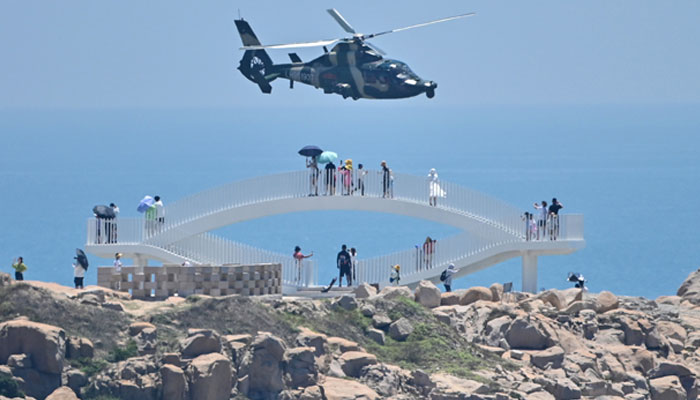 Chinese military helicopters fly past Pingtan island, one of mainland China’s closest points to Taiwan, in Fujian province on August 4, 2022. — AFP