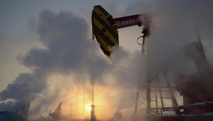 A pump jack is seen surrounded by steam during sunset at PetroChinas oil field in Karamay, Xinjiang Uigur Autonomous Region January 5, 2011. — Reuters/File