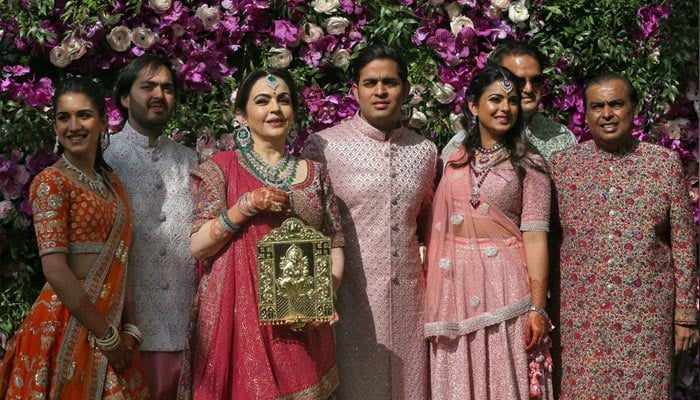 (L-R) Radhika Merchant, Anant Ambani, Nita Ambani, Akash Ambani, Isha Piramal, Anand Piramal and Mukesh Ambani, the Chairman of Reliance Industries, pose during a photo opportunity at the wedding ceremony of Akash, at Bandra-Kurla Complex in Mumbai, India, March 9, 2019. — Reuters/File