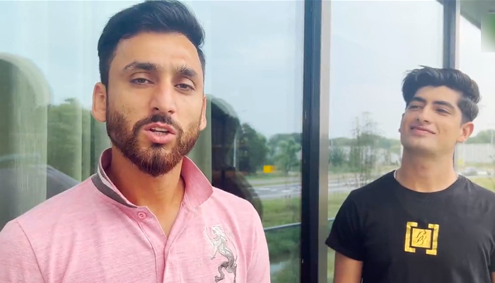 Pacer Naseem Shah (right) and all-rounder Salman Ali Agha speak during a video from Rotterdam, on August 15, 2022. — Twitter/PCB