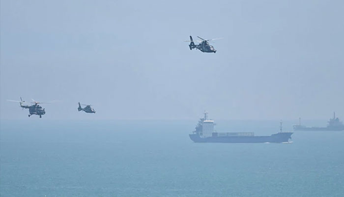 Chinese military helicopters fly past Pingtan island, one of mainland Chinas closest point from Taiwan, in Fujian province on August 4, 2022. — AFP