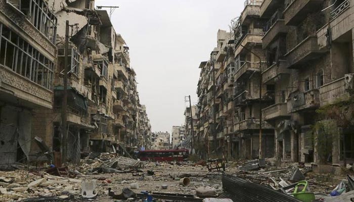 A bus blocks a road amid damage on the Salah Al-Din neighbourhood frontline in Aleppo, December 6, 2014.— Reuters/File