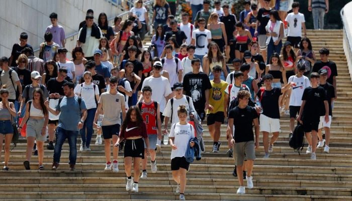Young people walk near the Guggenheim Museum, in Bilbao, Spain June 17, 2022. — Reuters