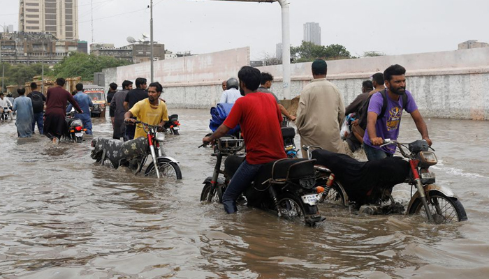Residents commute through a flooded road during the monsoon season in Karachi, Pakistan July 9, 2022. — Reuters