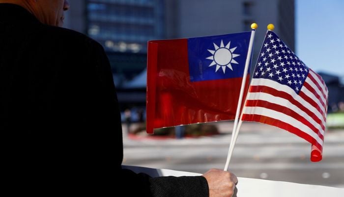 A demonstrator holds flags of Taiwan and the United States in support of Taiwanese President Tsai Ing-wen during an stop-over after her visit to Latin America in Burlingame, California, U.S., January 14, 2017. — Reuters