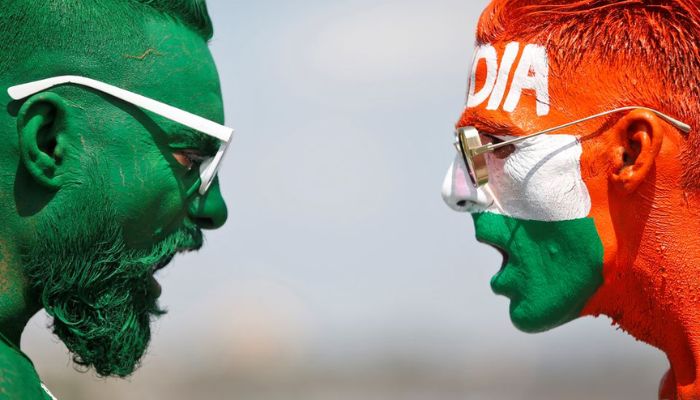 Cricket fans, with their faces painted in the Indian and Pakistani national flag colours, pose for a picture ahead of the first match between India and Pakistan in Twenty20 World Cup super 12 stage in Dubai, in Ahmedabad, India, October 23, 2021. — Reuters