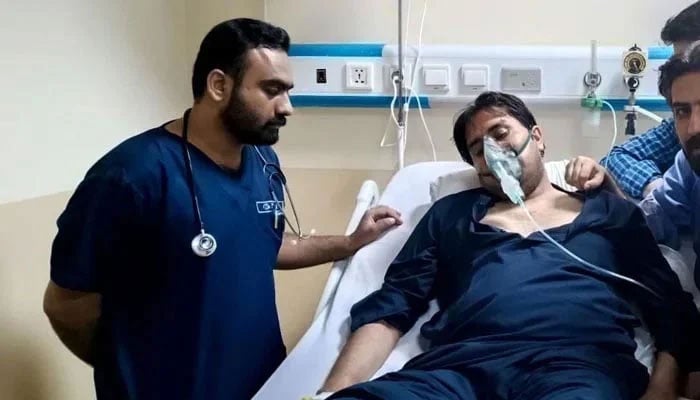 Shahbaz Gill seen lying on a hospital bed with an oxygen mask on. Twitter