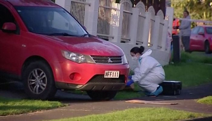 An investigator works at the scene where suitcases with the remains of two children were found, after a family, who are not connected to the deaths, bought them at an online auction for an unclaimed locker, in Auckland, New Zealand, August 11, 2022 in this still image taken from video. —  Reuters