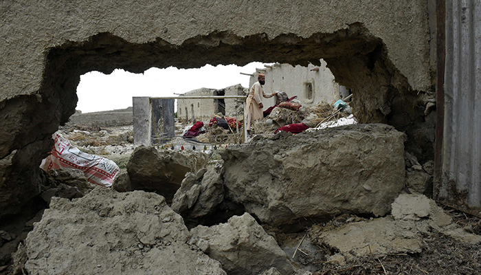 Flood-affected residents clear debris after the dam in Pishin district of Balochistan broke due to heavy rains on July 7, 2022. — AFP