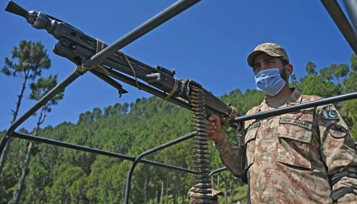 A Pakistani soldier patrols near the Line of Control at Salohi village in Poonch district of Azad Jammu and Kashmir on April 26, 2021. — AFP