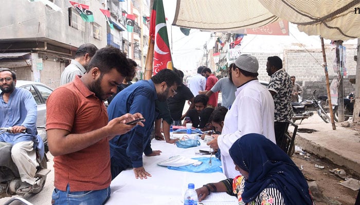A voter at a PTI camp outside a polling station during the NA-245 by-poll. — NNI