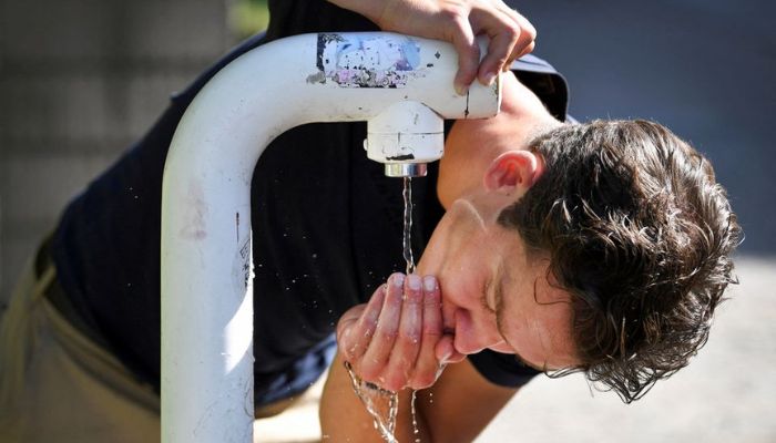 A man drinks water from a public drinking establishment during a heatwave in Nijmegen, Netherlands July 18, 2022. — Reuters