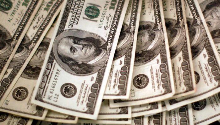 Four thousand US dollars are counted out by a banker counting currency at a bank in Westminster, Colorado November 3, 2009. — Reuters