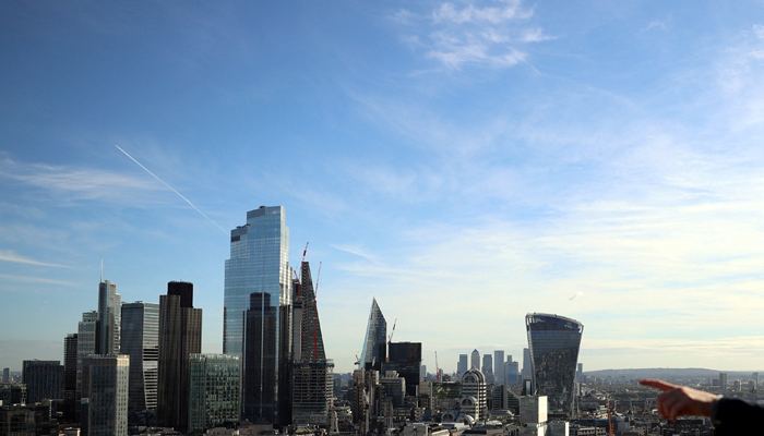 A person points to the City of London financial district from a viewing platform in London, Britain, October 22, 2021. — Reuters