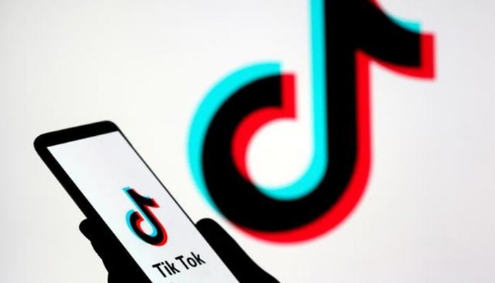 A person holds a smartphone with the TikTok logo displayed in this picture illustration. — Reuters/File